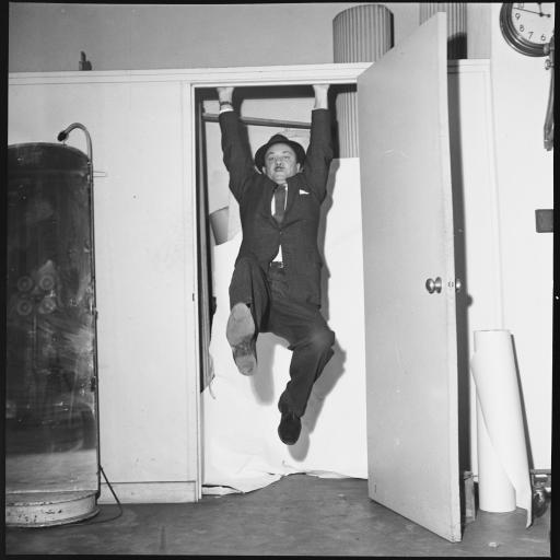 A man hanging from a doorframe