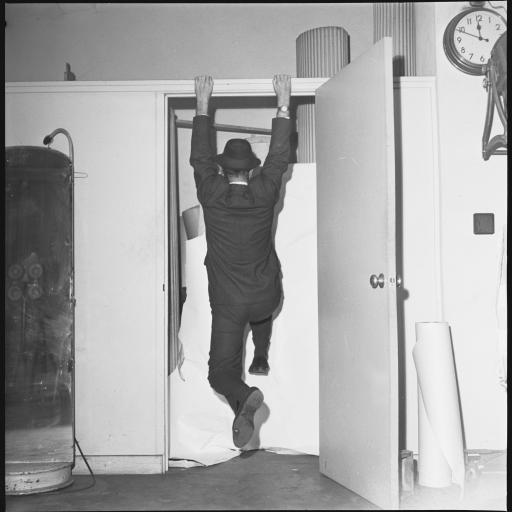A man hanging from a doorframe