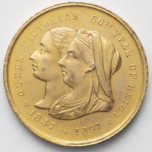A coin with an engraving of two heads 