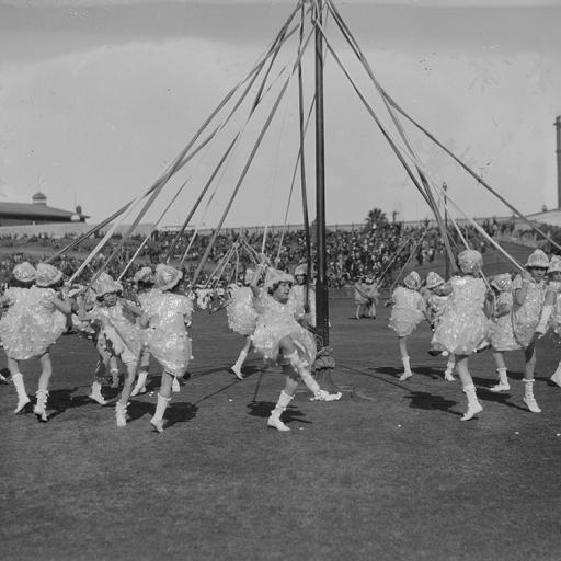 Children skipping around a maypole