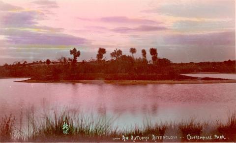 A picture of a lake with trees and clouds